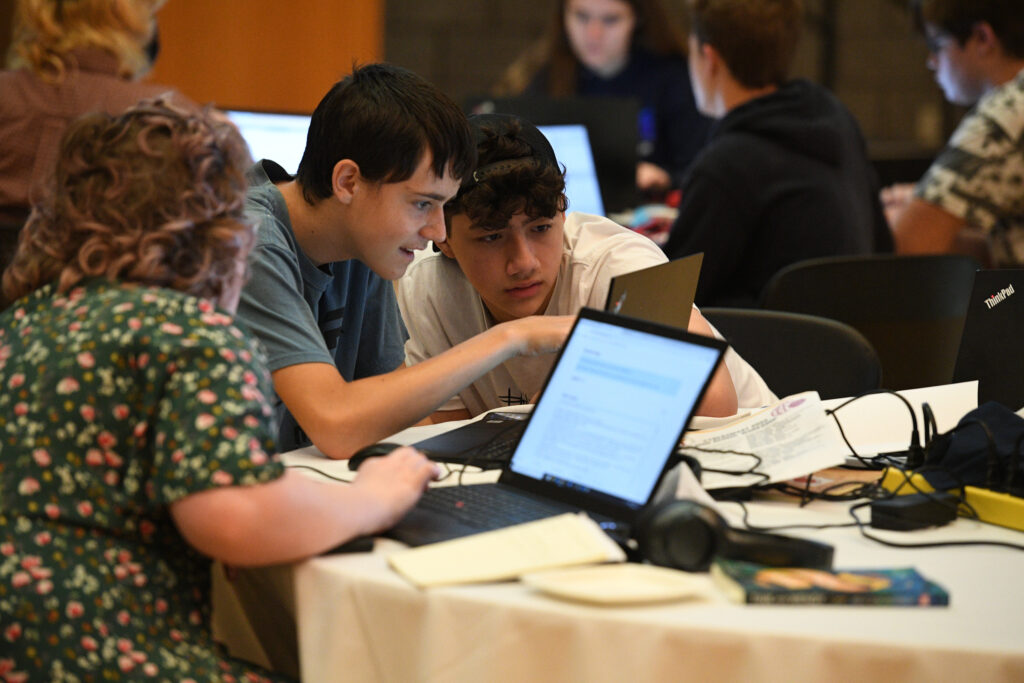 Past participants engage in a cryptography exercise.