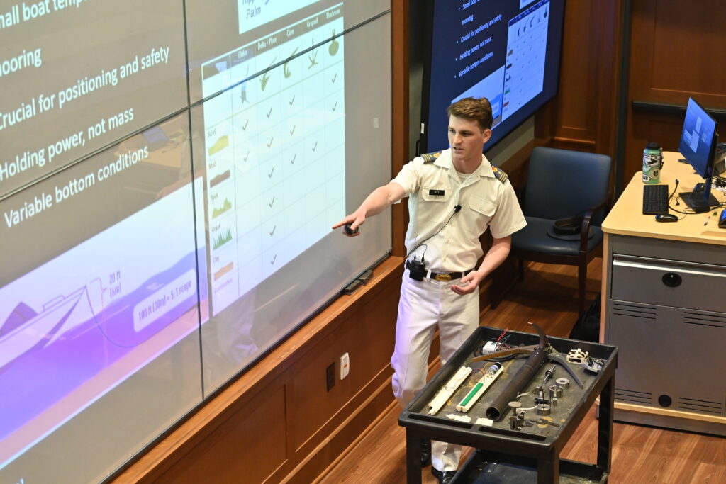 A cadet points to a screen during his Honors Week presentation.