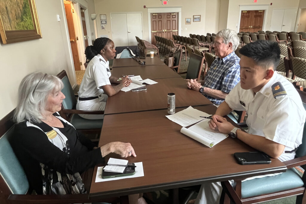 Cadets and residents sit together to talk.