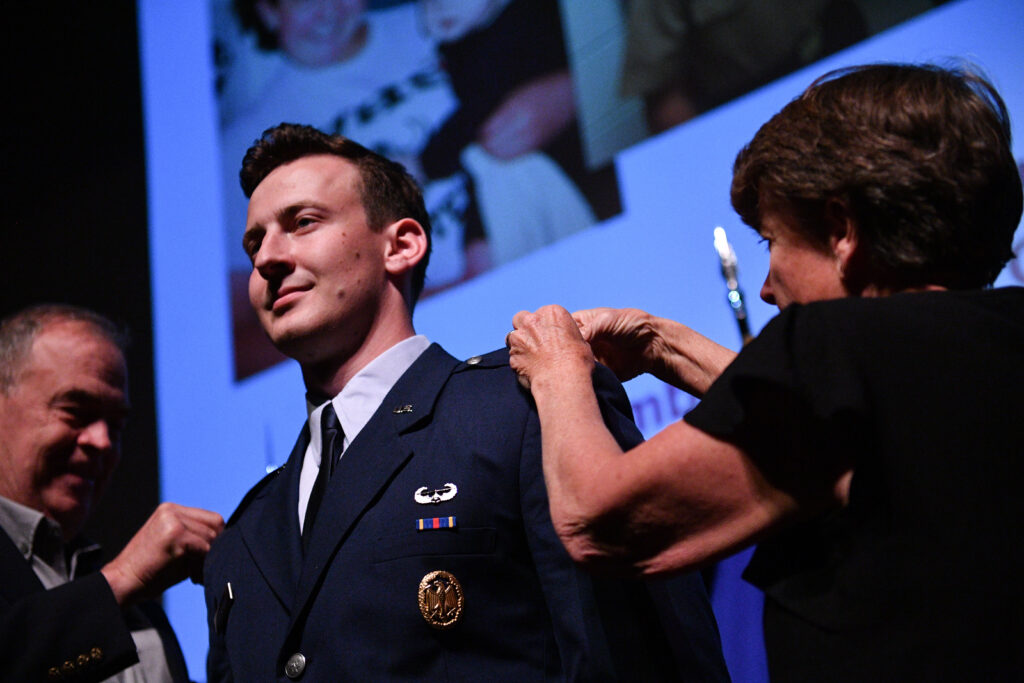 A newly commissioned Second Lieutenant receives his insignia from family  during the Air Force ROTC pin-on ceremony at VMI.